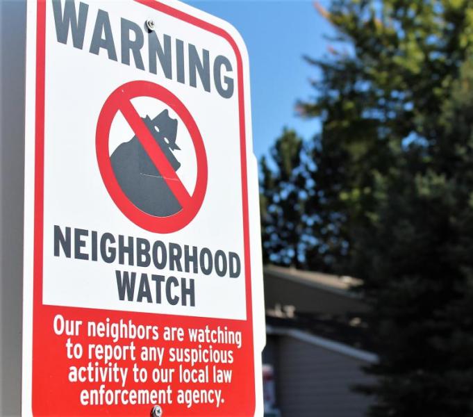 Photos by Brett Fisher. A neighborhood watch sign at the entrance to a residential community in Carson City.