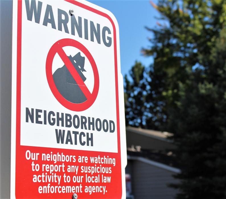 Photos by Brett Fisher. A neighborhood watch sign at the entrance to a residential community in Carson City.