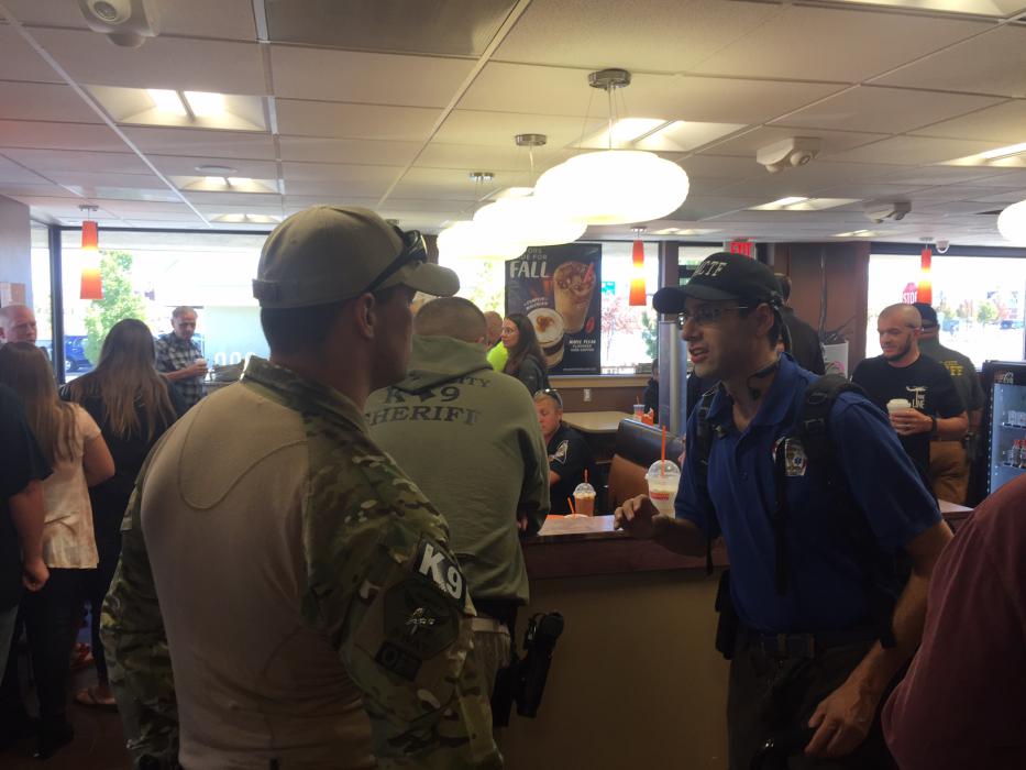 CCSO Deputy Brett Bindley and Daniel Andrews share a conversation.