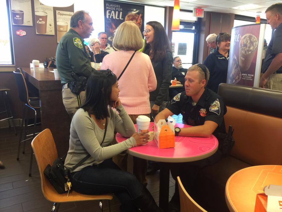 Kim Buchanan and NHP Trooper Max Davis share a conversation over coffee.