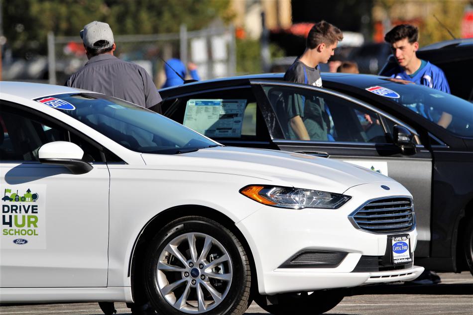 CHS football players check out a new Ford sedan Saturday.