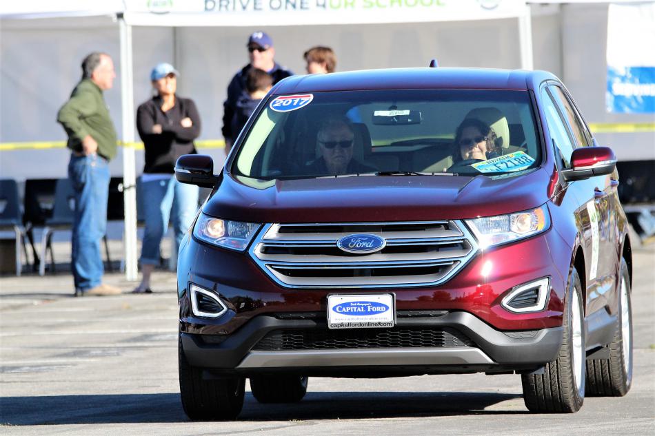 A couple takes a compact Ford SUV for a test spin Saturday at CHS.