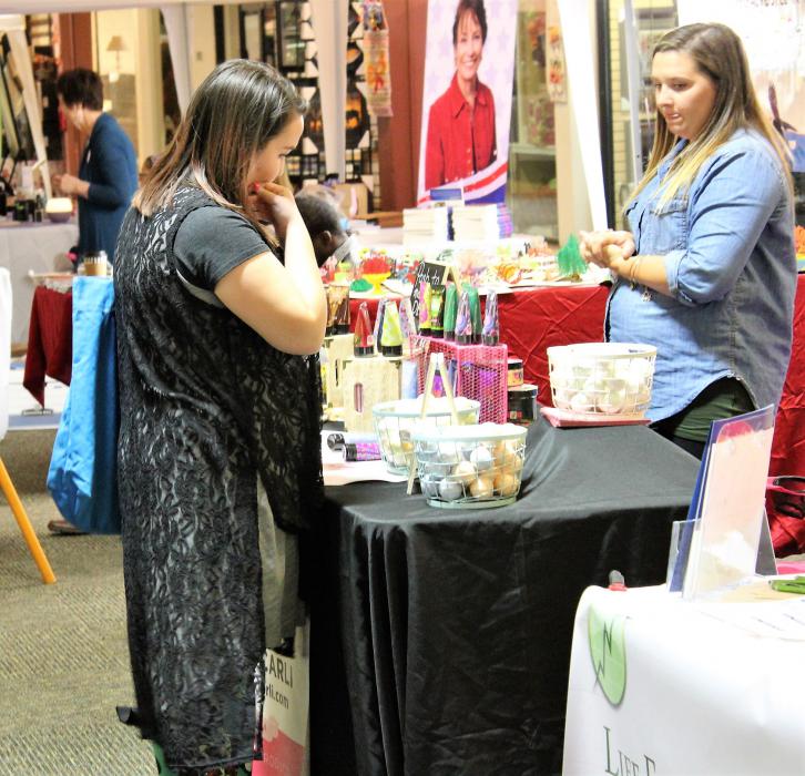 A shopper browses products and vendor booths at the Nevada Women's Expo Friday night at the Carson Mall.