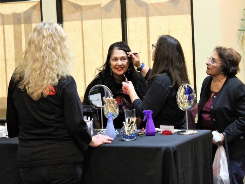 Photos by Brett Fisher. A woman gets a makeover demonstration Friday night at the Nevada Women's Expo inside the Carson Mall.