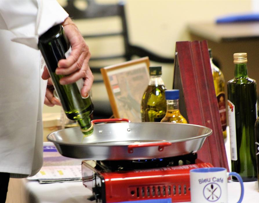 Fine Portugese olive oil coats a skillet that will cook traditional Spanish Paella.