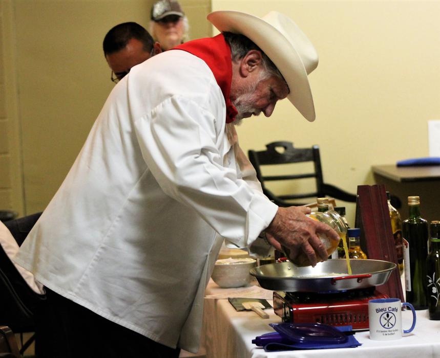 Chef Don Pepe adds chicken stock to the base of his Paella.