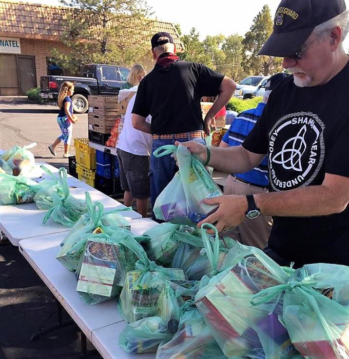 Sacks of groceries are assembled for distribution.