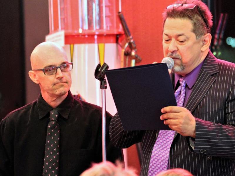 Photos by Brett Fisher. Dan Kimm, right, reads a Carson City proclamation to honoree Mark Lindquist Friday night.