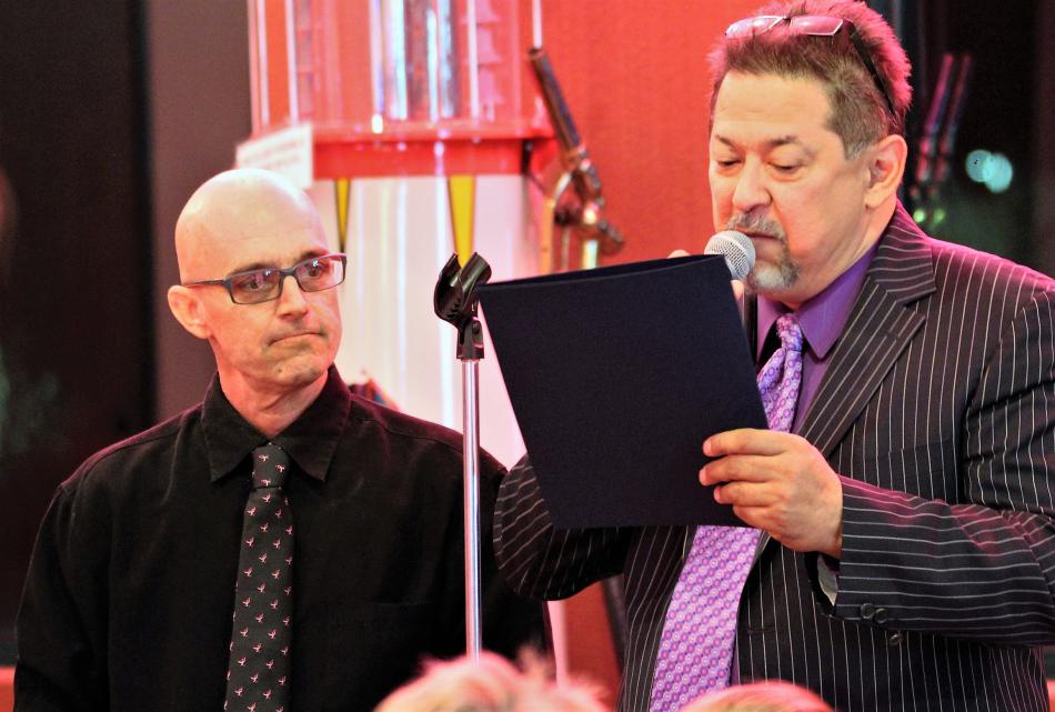 Photos by Brett Fisher. Dan Kimm, right, reads a Carson City proclamation to honoree Mark Lindquist Friday night.