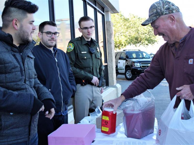 Photo by Brett Fisher. Used syringes are turned in at Smith's Saturday during the Fall Prescription Drug Roundup.