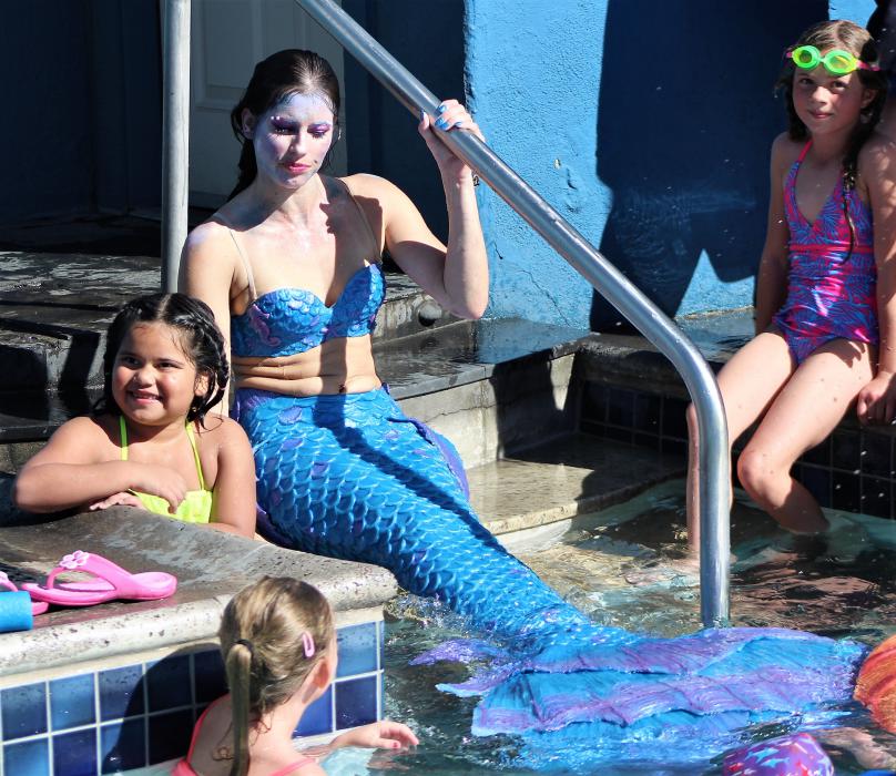 Mermaid Megan sits on the edge of the pool at Carson Hot Springs Resort.