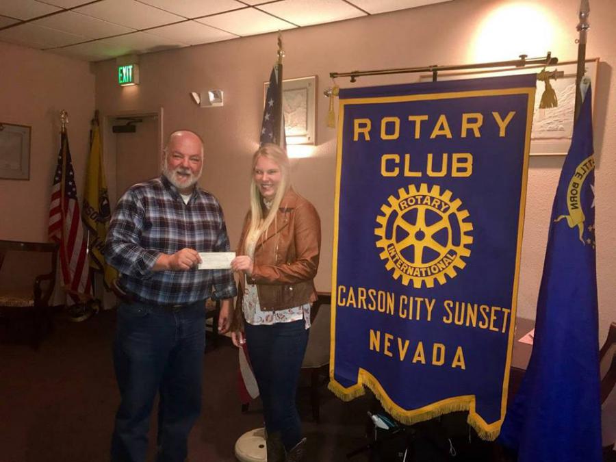 Rotary Club President presents scholarship to Maddi Saarem