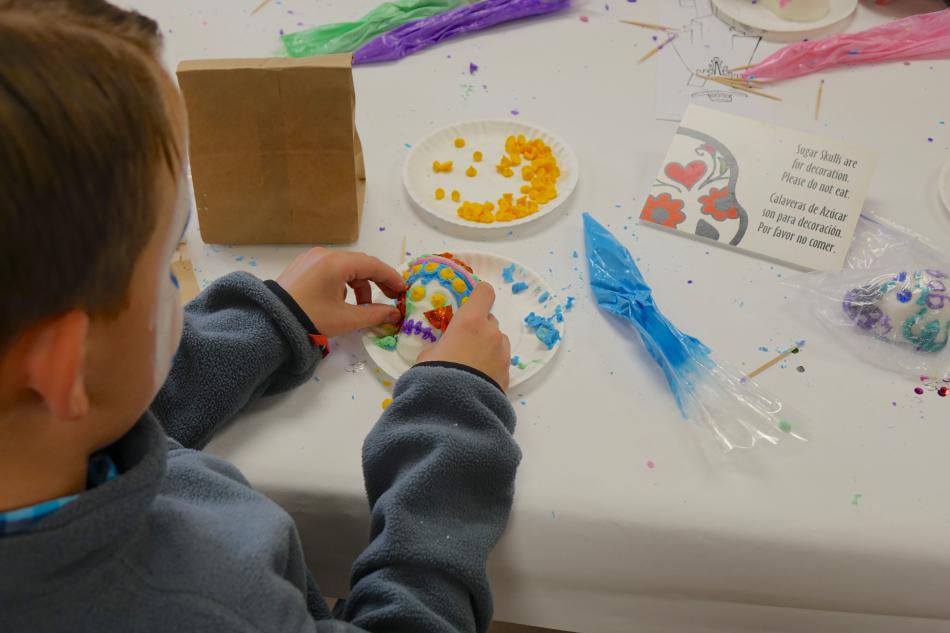 A boy crafting a sugar skull