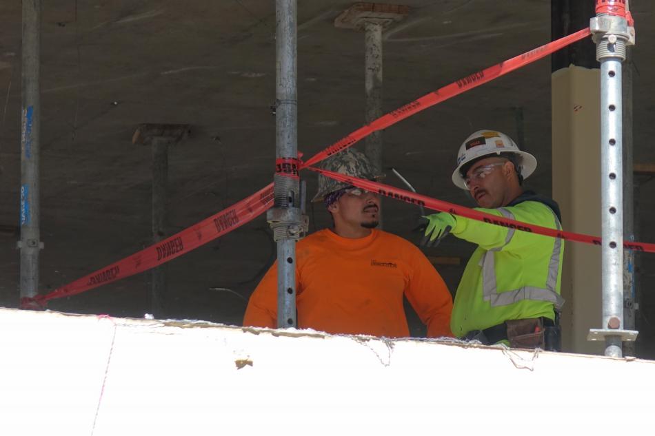 Construction workers having a discussion on the 2nd floor