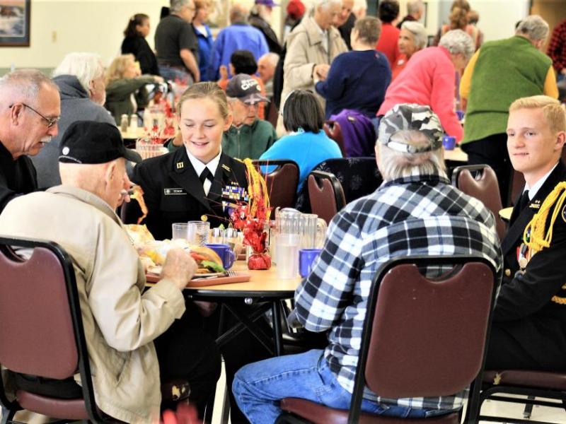 CTE Cadet Zanor, Marine Corps, and Cadet Bergren, Coast Guard, share a meal with veterans at the Carson City Senior Center.