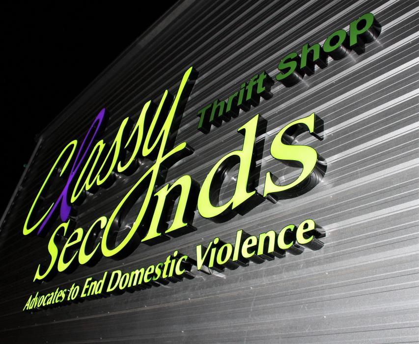 Photos by Brett Fisher. The all-new Classy Seconds sign glows Thursday evening during a grand opening celebration.