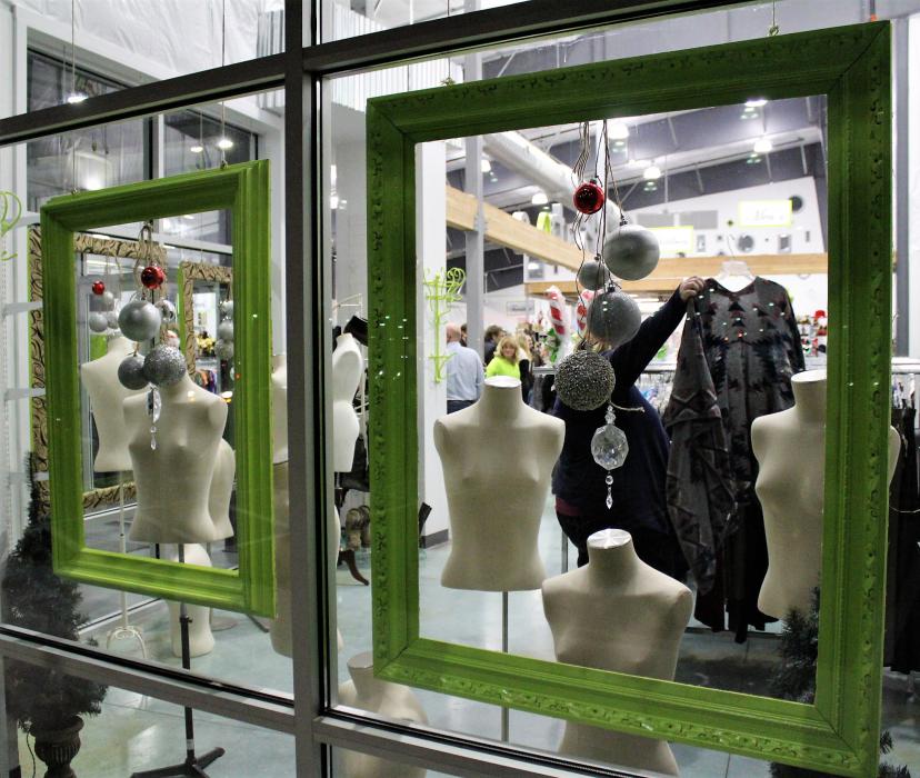 A guest looks over a clothing rack inside the all-new Classy Seconds.