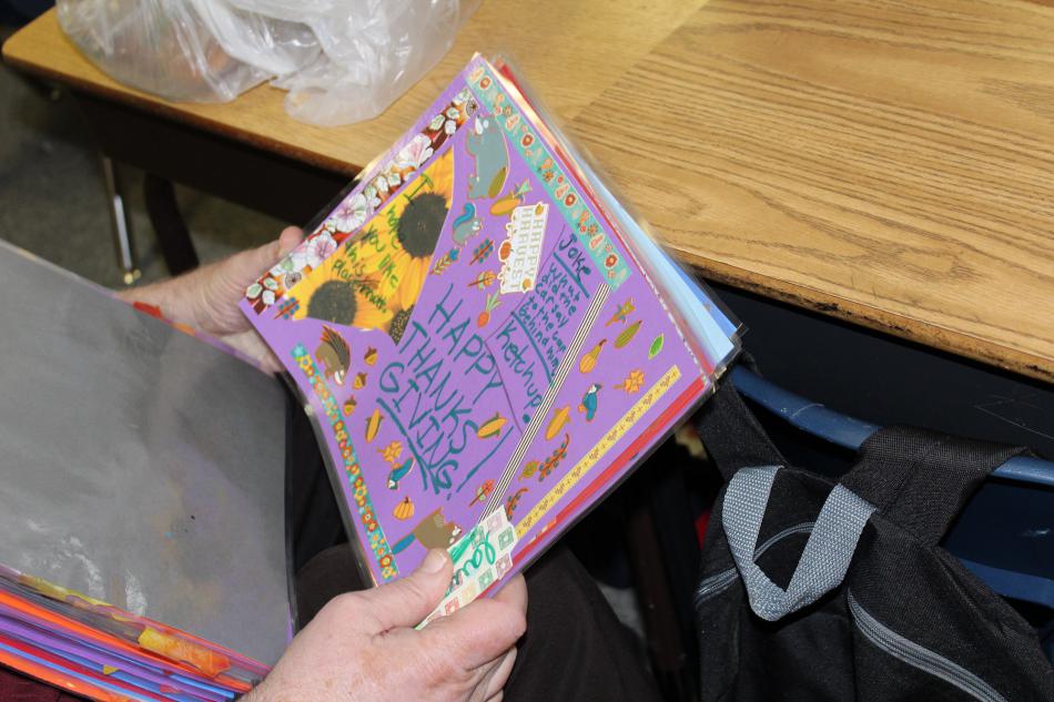 Looking through Thanksgiving placemats made by Bordewich-Bray students for Carson City seniors using Meals On Wheels.