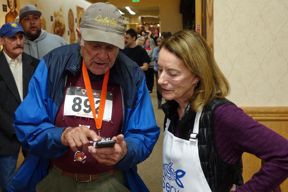 Susan Crowell viewing some pictures on a guests phone
