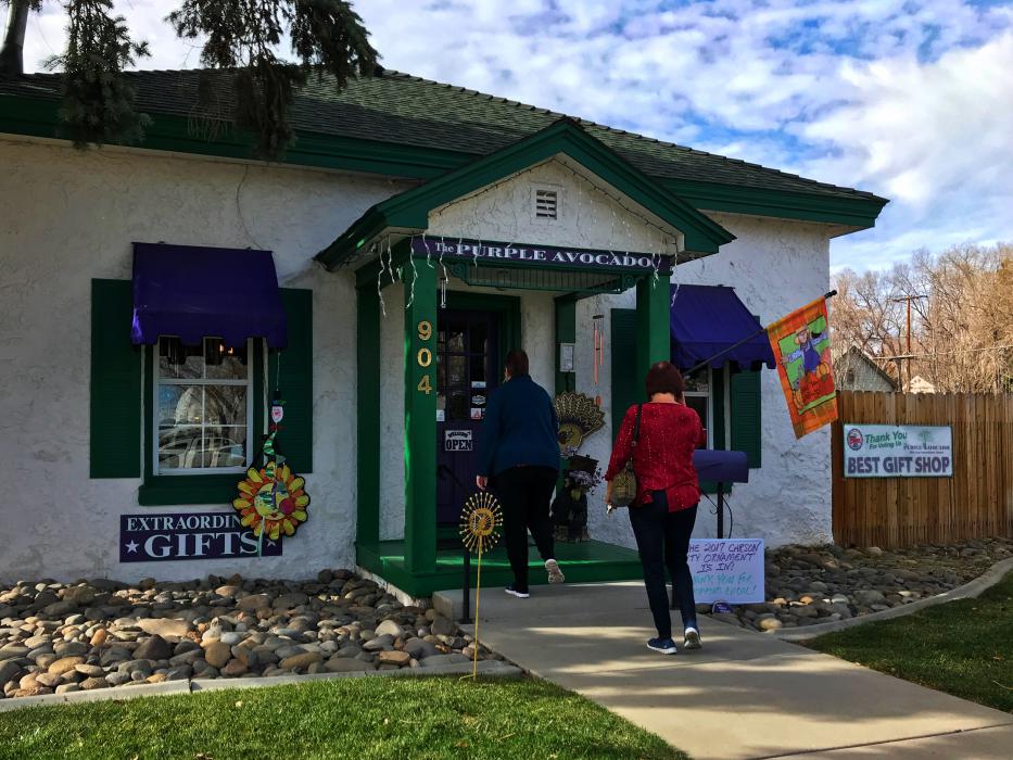 A pair of shoppers enter The Purple Avocado