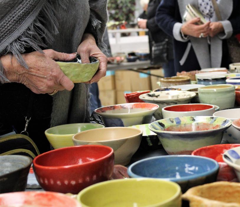 Guests select their bowls Friday night during the Empty Bowls fundraiser.