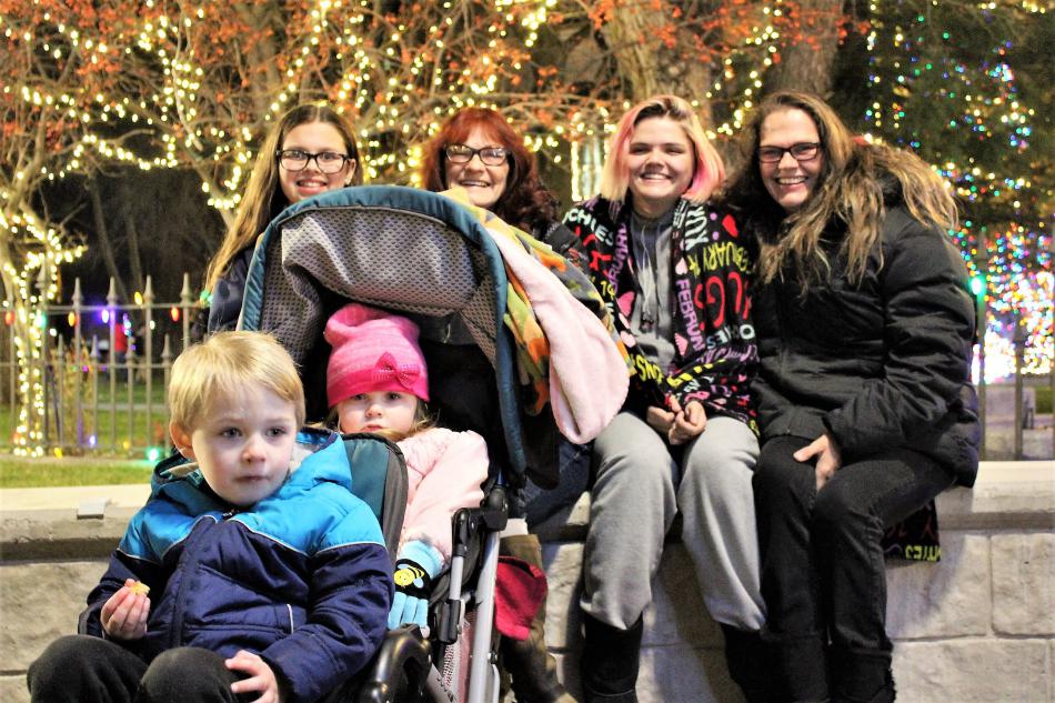 A five-generation family poses in front of the Capitol grounds after the tree lighting ceremony.