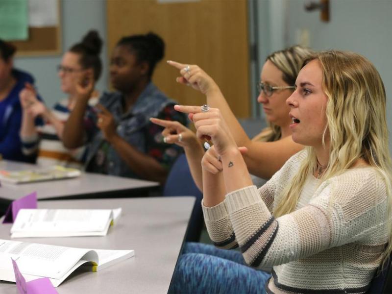 Rachael Seabert, right, and other students work in an American Sign Language class on Sept. 19, 2017, at Western Nevada College