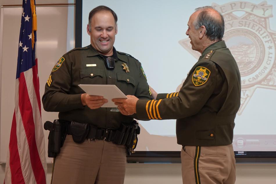 Supervisor of The Year Sgt. Craig Lowe accepts his plaque by Sheriff Furlong.