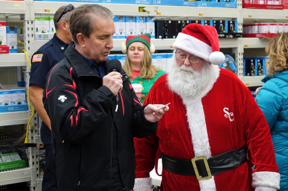 Mayor Bob Crowell gifts Santa a Carson City coin.