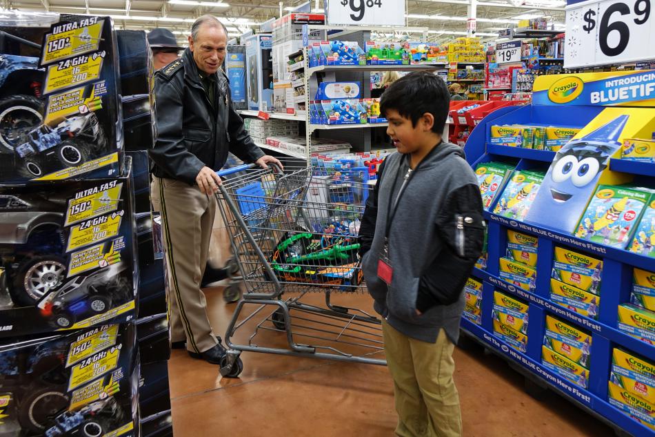 Carson City Sheriff Kenny Furlong helps choose a toy