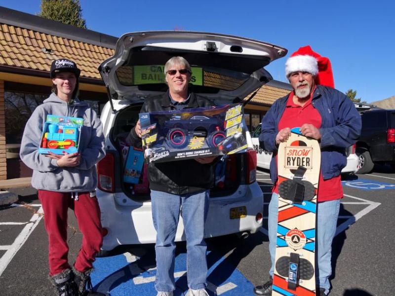 From left: Teslah Cunningham, Barry Lawless, Mark Shefler unloading their cab cars at Ron Wood Center