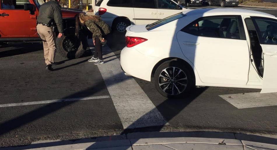 A deputy and a victim inspect damages to vehicles following a suspected DUI hit and run Thursday at Roop and William streets.