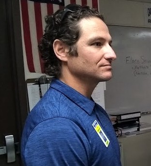 CHS teacher Ty McMillen listening to FCA guest Flora Savai.