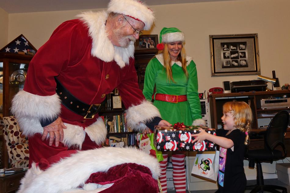 Santa Ed Brown and helper Karen Jessop make a Christmas Eve stop.