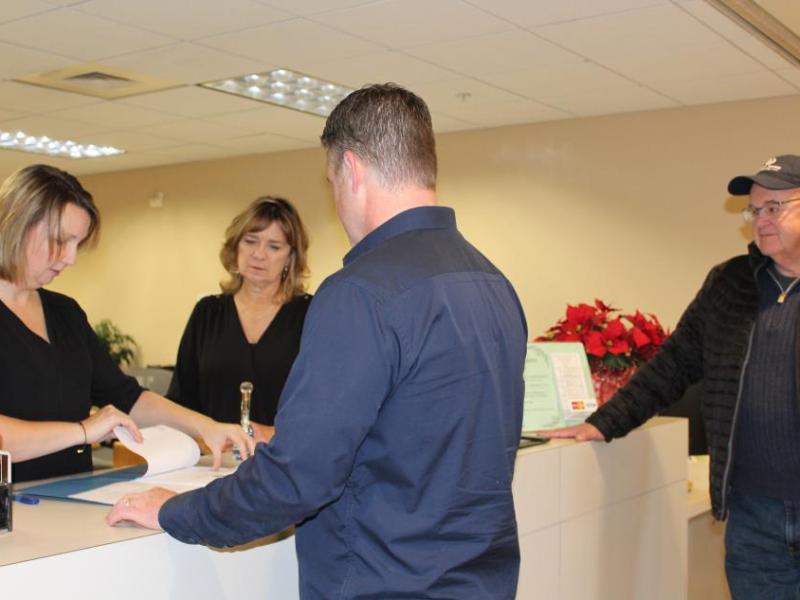 Ryan Russell files candidacy paperwork Tuesday in Carson City as his father, Rich Russell, looks on.