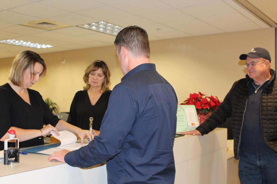 Ryan Russell files candidacy paperwork Tuesday in Carson City as his father, Rich Russell, looks on.
