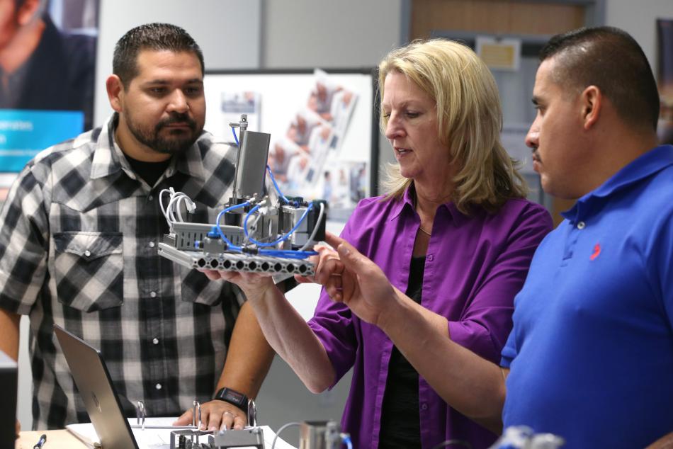 Applied Industrial Technology professor Emily Howarth talks with Ricardo Fregoso and Ezequiel Varela during class at WNC.