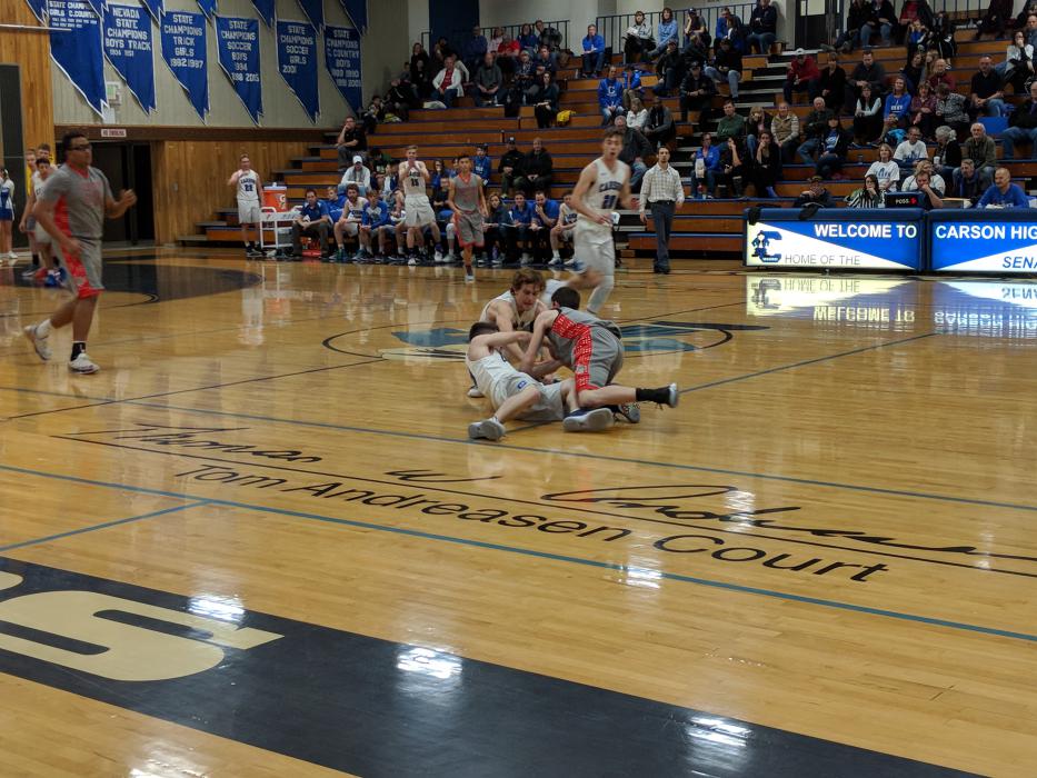 Junior guards Hunter Rauh and Jordan Torres dive for a loose ball.