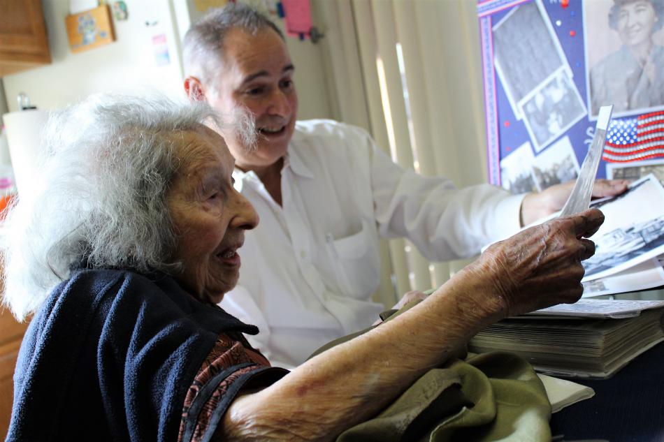 Sara Boogay Garcia and her son, Greg, look at old photographs of her WWII service.
