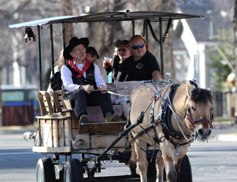 Photo by Brett Fisher. A horse-drawn taxi transports Wine Walk participants to downtown Carson City venues Saturday.