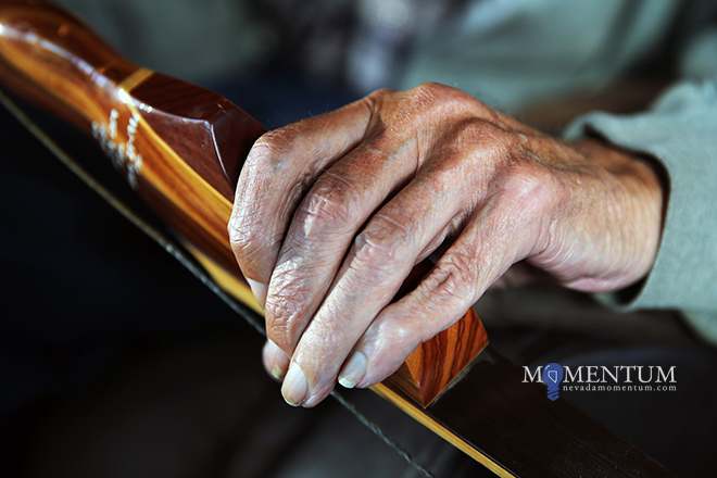 Photos by Lance Iversen/Nevada Momentum. Tim Meigs' hand clasps one of his custom bows.