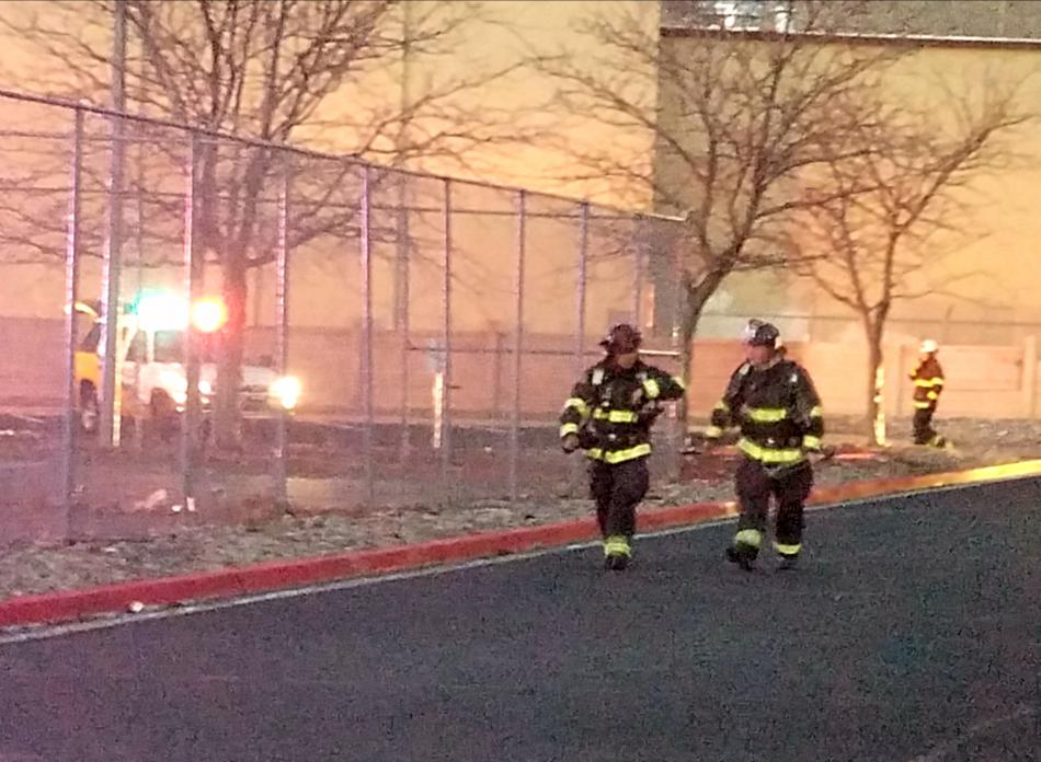 Photo by Brett Fisher. Firefighters finishing up at the scene of the Broadleaf Manor apartment fire.
