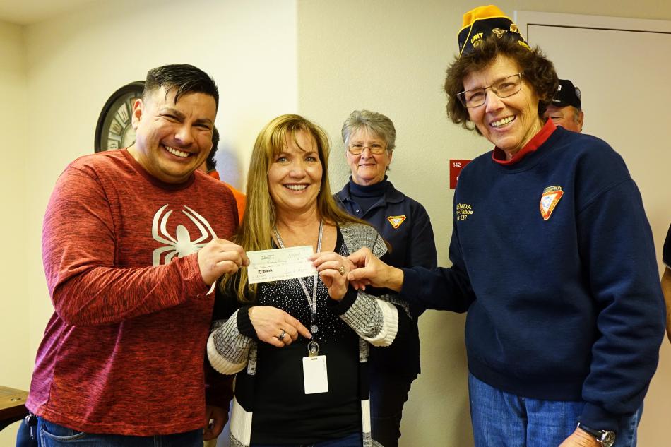 Joe Sylvester, Danielle Erickson of Richards Crossing accept donation from Brenda Horton