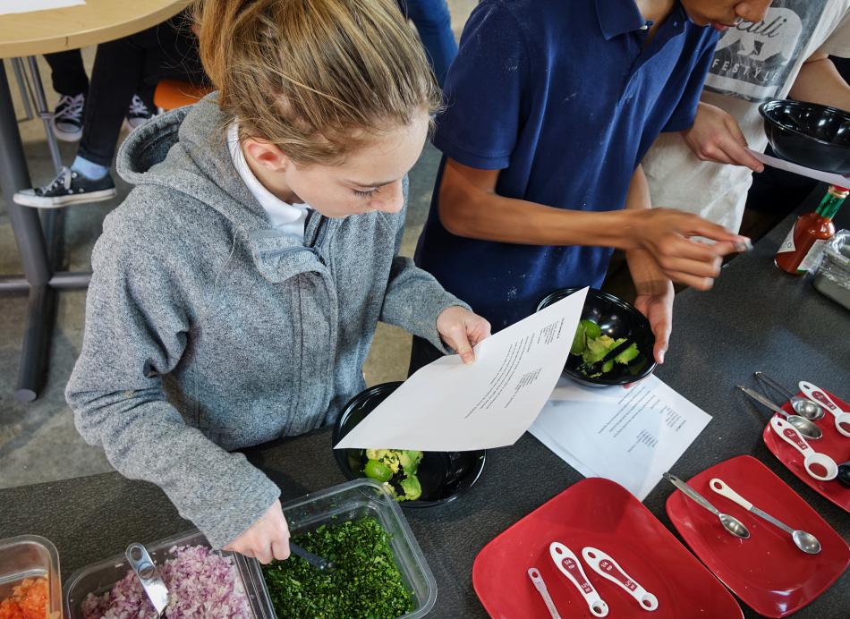 Seventh grader Makenna Malone follows Chef Hurzel's guacamole recipe