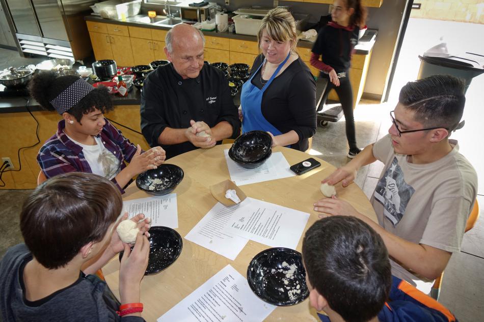Club members learning how to make tortillas