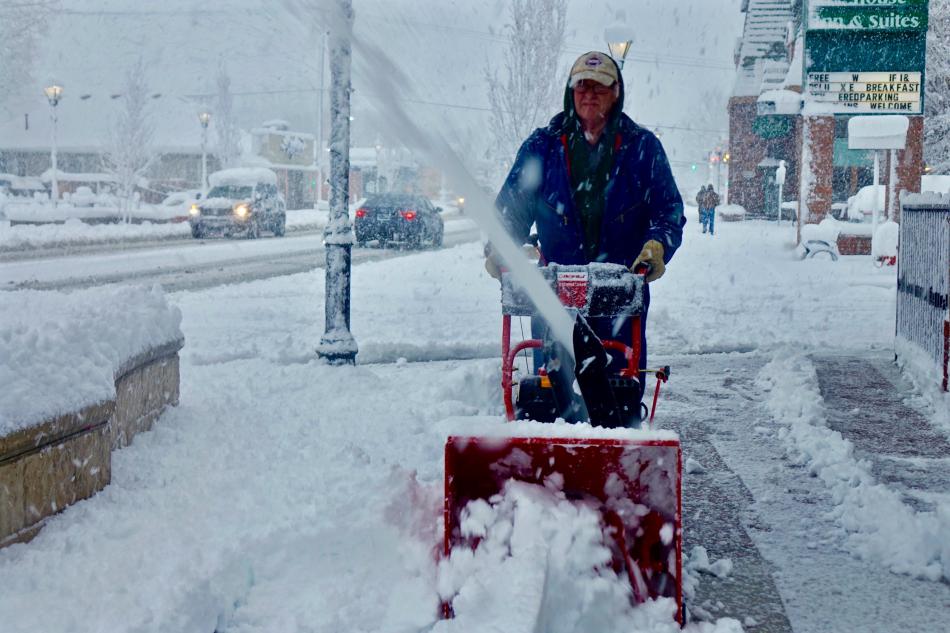 A snowblower operator clears the sidewalk by the Northern Nevada Children's Museum Friday morning.