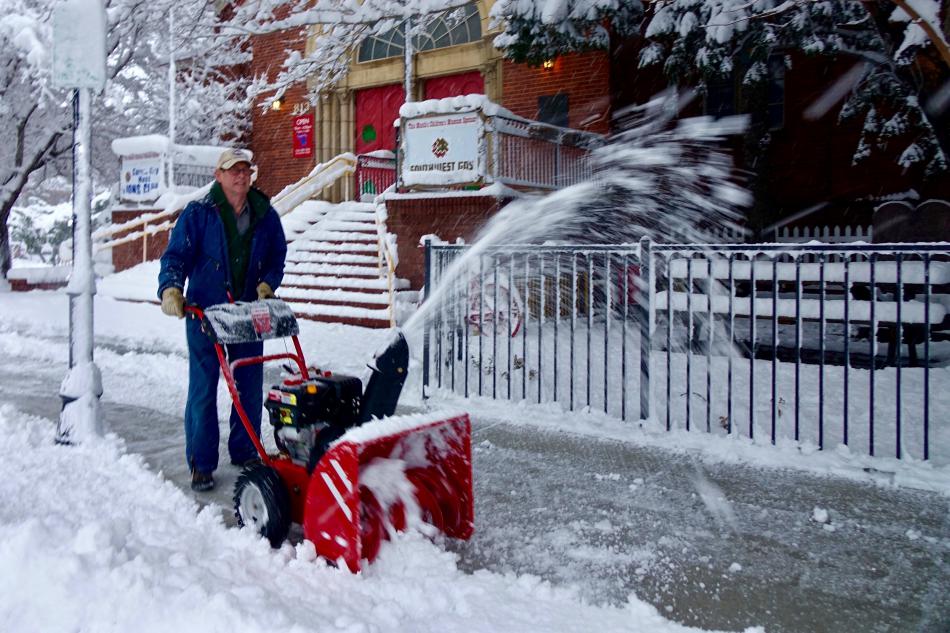 A snowblower operator clears the sidewalk by the Northern Nevada Children's Museum Friday morning.