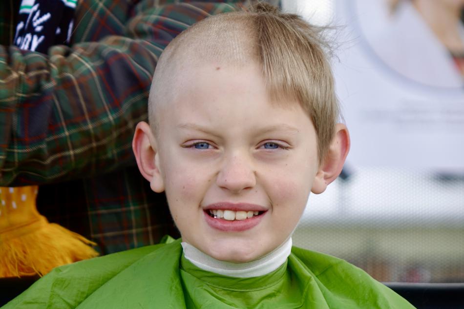 Lucas Goss, 9, precisely half way through his cut.