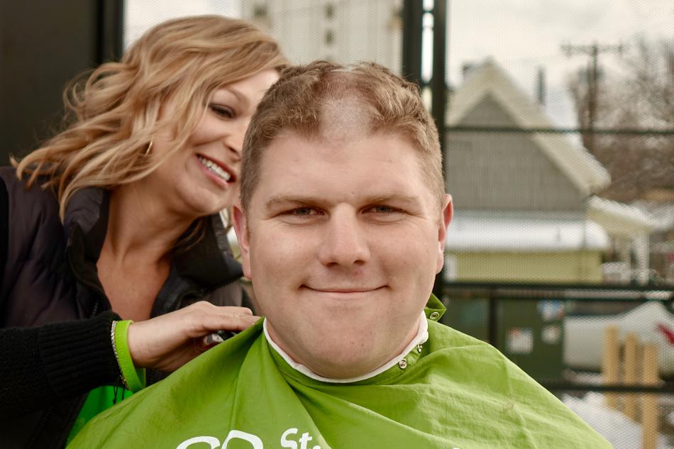 Photos by Jim Gustafson. Carson City Firefighter Matt Cooper gets his buzz from Stylist Ashleigh Fisicaro.