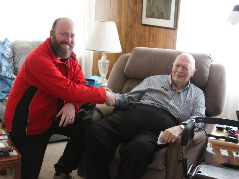 Randy Gaa, founder of Meals on Two Wheels, visits with Monte Fast, former executive director of FISH.